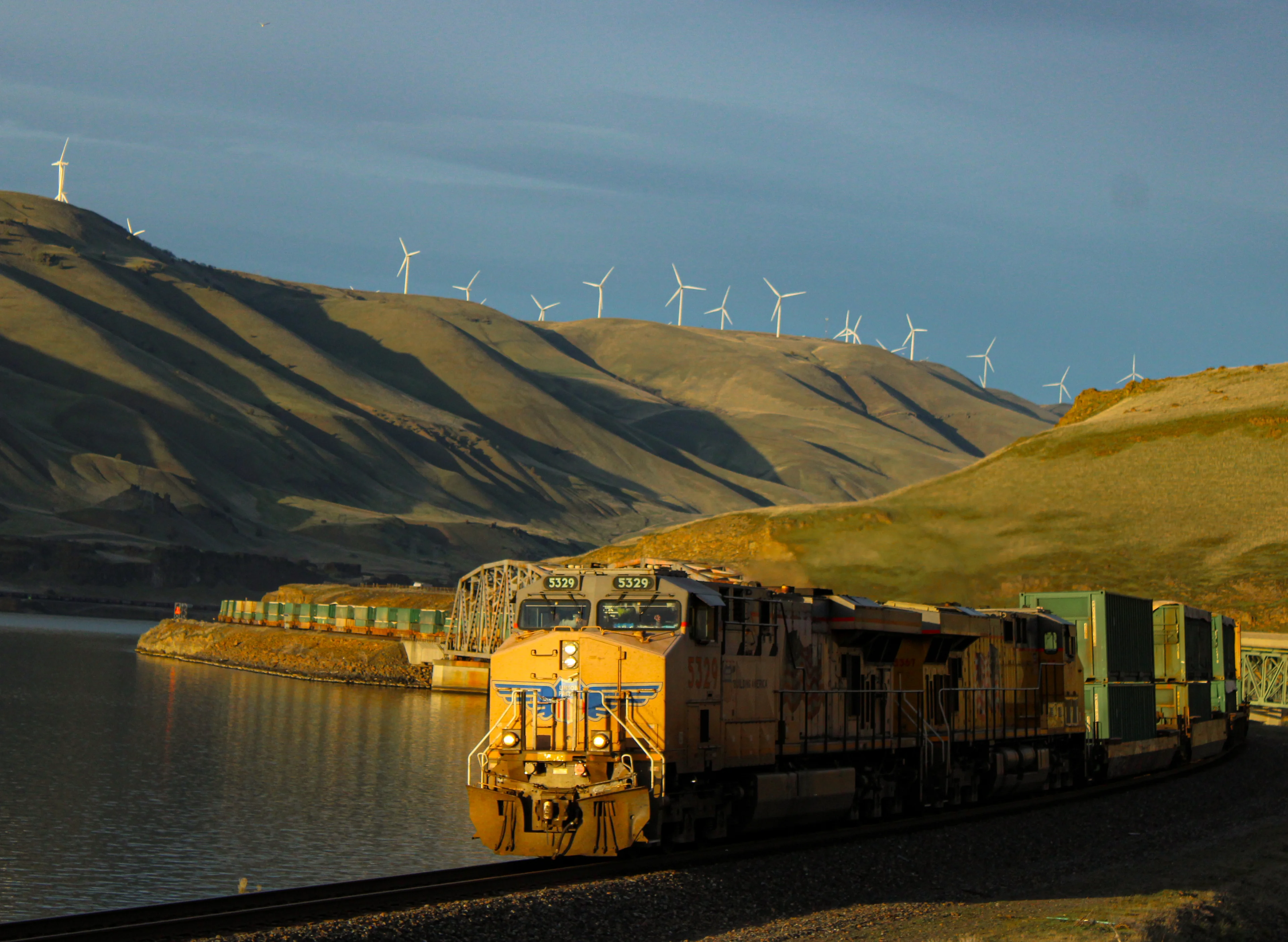 Seattle-bound garbage empties crossing the bridge at sunset.